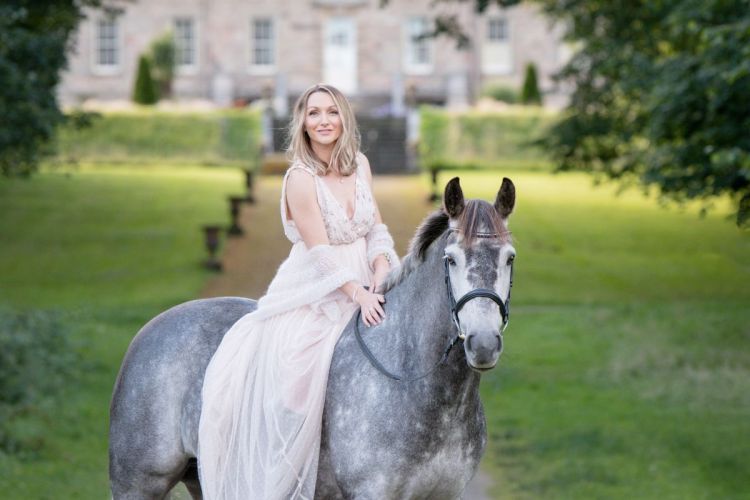 A woman bareback riding her horse