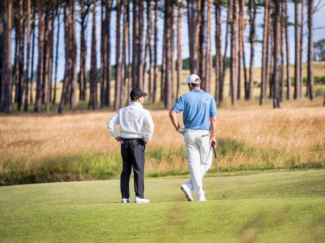 Scottish Scheffler talking with amateur player